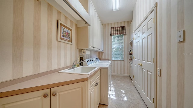 clothes washing area featuring cabinets, washing machine and dryer, sink, and light tile patterned flooring