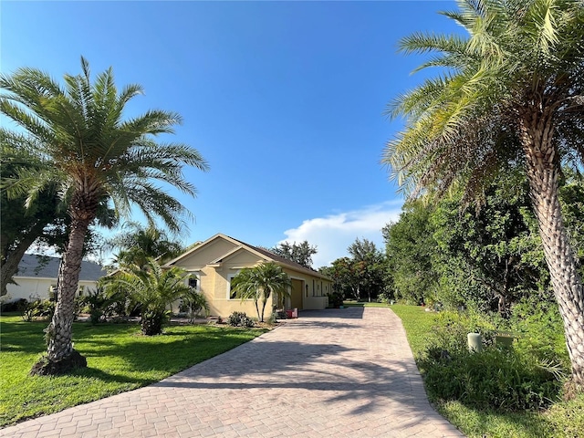 15207 17th Ave E, Bradenton, FL 34212 - view of front of property featuring decorative driveway, a front yard, and stucco siding