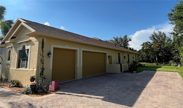15207 17th Ave E, Bradenton, FL 34212 - view of home's exterior with stucco siding, an attached garage, and decorative driveway