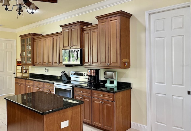15207 17th Ave E, Bradenton, FL 34212 - kitchen featuring stainless steel appliances, dark stone counters, crown molding, glass insert cabinets, and a kitchen island