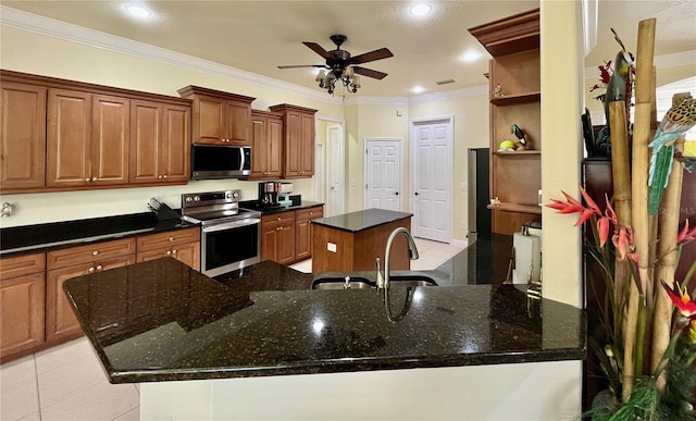15207 17th Ave E, Bradenton, FL 34212 - kitchen featuring appliances with stainless steel finishes, a kitchen island, light tile patterned floors, ornamental molding, and a ceiling fan