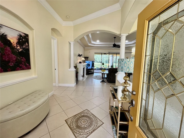 15207 17th Ave E, Bradenton, FL 34212 - entrance foyer with decorative columns, arched walkways, crown molding, ceiling fan, and light tile patterned flooring