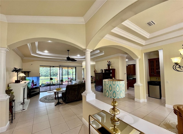 15207 17th Ave E, Bradenton, FL 34212 - living area with a raised ceiling, a ceiling fan, crown molding, ornate columns, and arched walkways