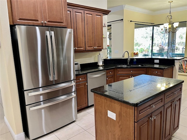 15207 17th Ave E, Bradenton, FL 34212 - kitchen featuring stainless steel appliances, a peninsula, light tile patterned floors, ornamental molding, and a chandelier