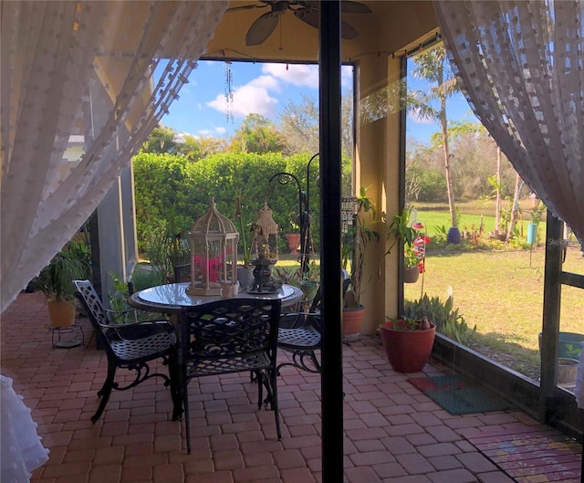 15207 17th Ave E, Bradenton, FL 34212 - sunroom with ceiling fan and outdoor dining space