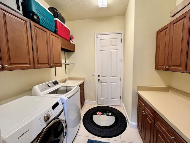 15207 17th Ave E, Bradenton, FL 34212 - washroom with washer and dryer, light tile patterned flooring, cabinet space, and a textured ceiling