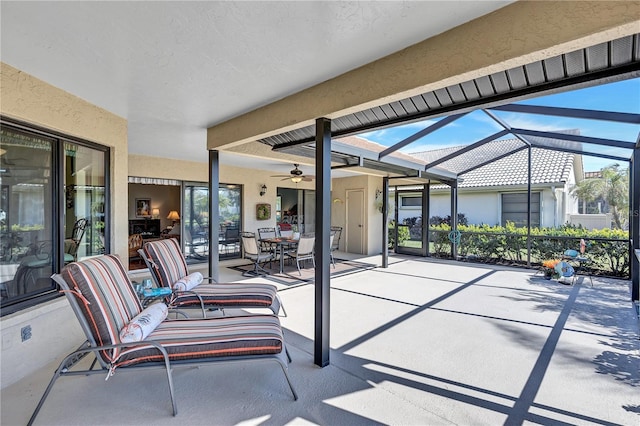 view of patio featuring glass enclosure