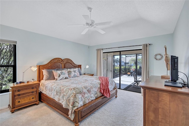 carpeted bedroom with lofted ceiling, access to exterior, a textured ceiling, and ceiling fan