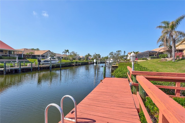 view of dock featuring a yard and a water view