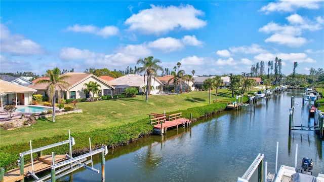 dock area featuring a water view and a yard