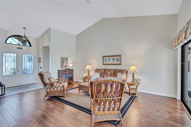 104 Inlets Blvd Unit 104, Nokomis, FL 34275 - living area featuring high vaulted ceiling, wood-type flooring, french doors, and baseboards