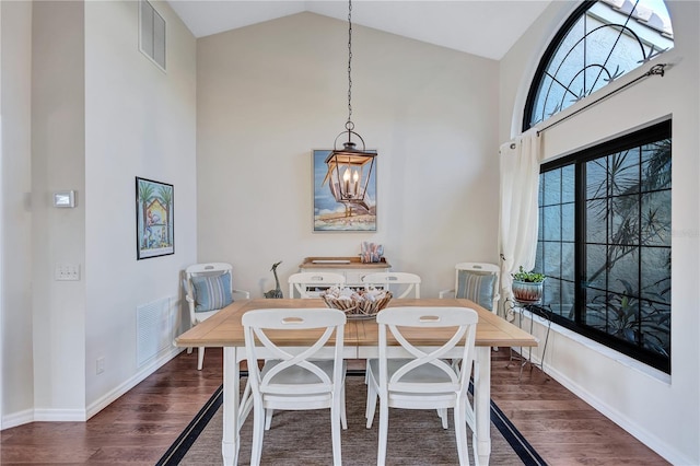 104 Inlets Blvd Unit 104, Nokomis, FL 34275 - dining space with high vaulted ceiling, wood finished floors, baseboards, and a chandelier