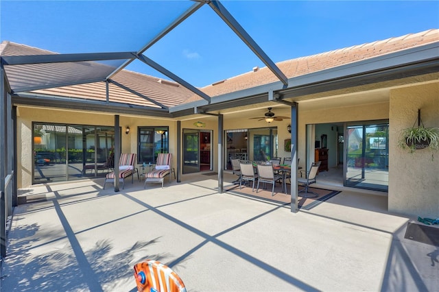 104 Inlets Blvd Unit 104, Nokomis, FL 34275 - rear view of house featuring a patio area, stucco siding, ceiling fan, outdoor dining space, and a lanai