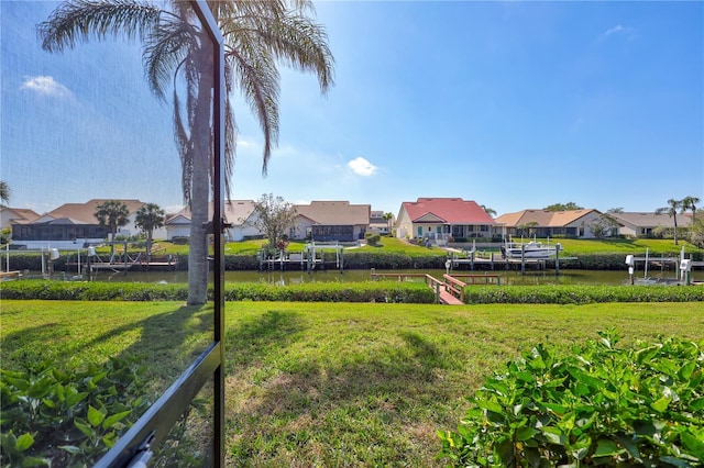 104 Inlets Blvd Unit 104, Nokomis, FL 34275 - view of grassy yard with a residential view, a water view, a boat dock, and boat lift