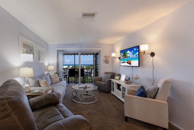 carpeted living room featuring a textured ceiling