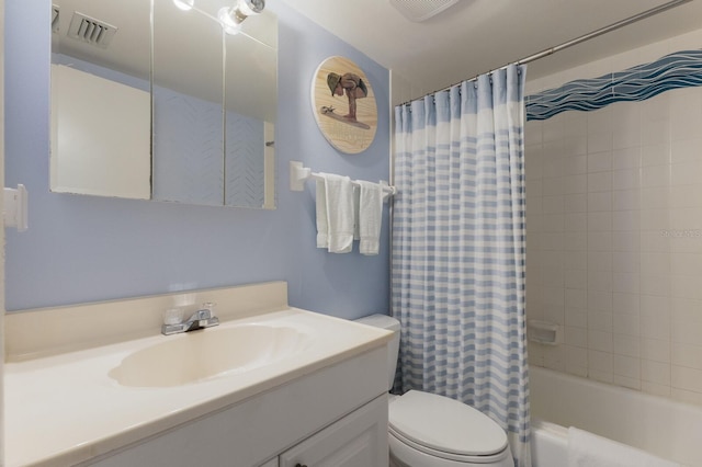 full bathroom with vanity, shower / bath combo with shower curtain, and toilet