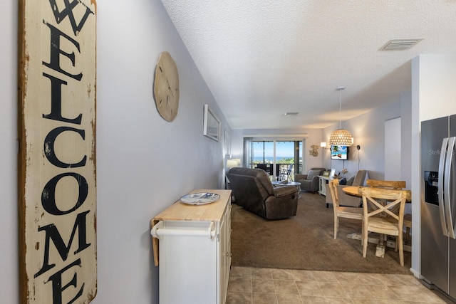 carpeted living room featuring a textured ceiling