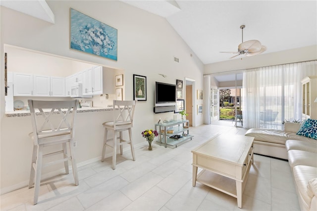 5618 Monte Rosso Rd, Sarasota, FL 34243 - living room with light tile patterned floors, high vaulted ceiling, and ceiling fan