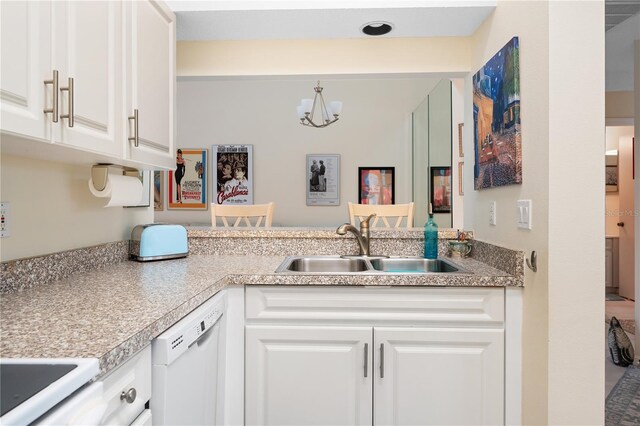 5618 Monte Rosso Rd, Sarasota, FL 34243 - kitchen with dishwasher, sink, white cabinets, a notable chandelier, and kitchen peninsula