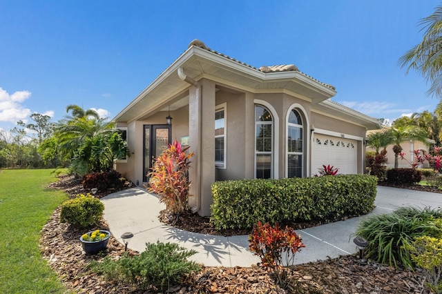 view of front of property featuring a garage and a front yard