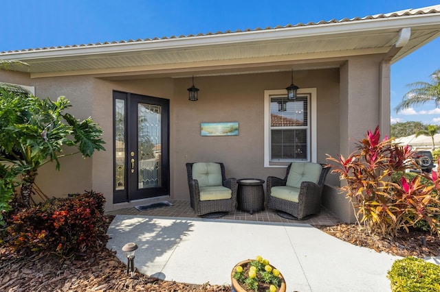 view of exterior entry featuring a patio