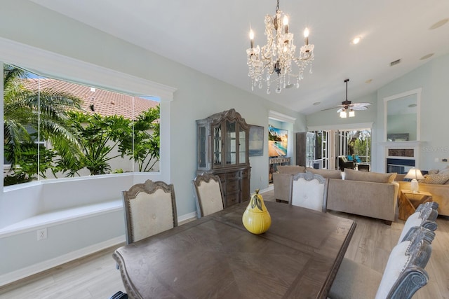 dining room with ceiling fan, lofted ceiling, and light hardwood / wood-style floors