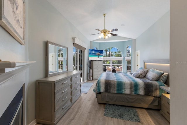 bedroom featuring ceiling fan, lofted ceiling, and light wood-type flooring