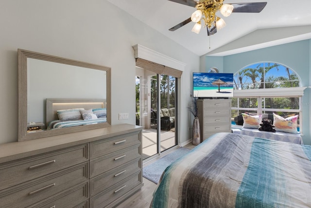 bedroom featuring lofted ceiling, access to exterior, multiple windows, and ceiling fan