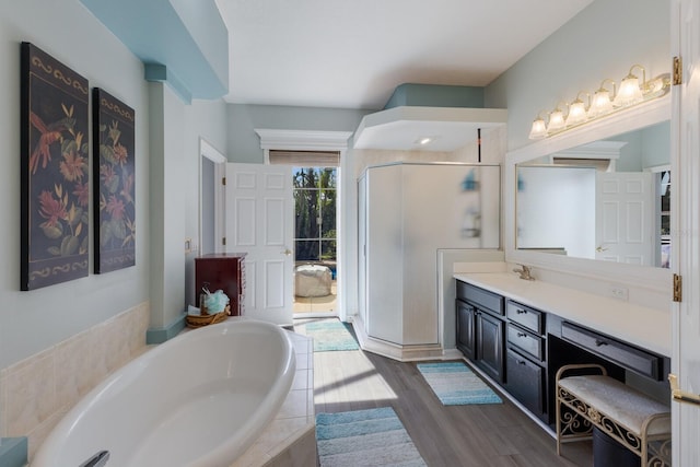 bathroom with vanity, separate shower and tub, and wood-type flooring