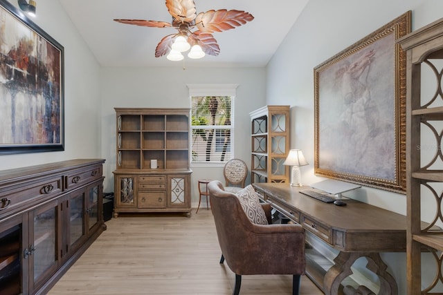 office with ceiling fan and light hardwood / wood-style flooring