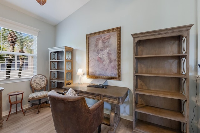 home office featuring vaulted ceiling and light wood-type flooring