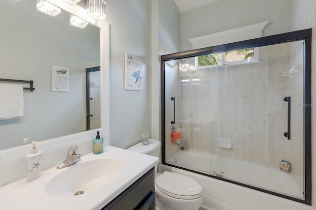 full bathroom featuring toilet, vanity, and bath / shower combo with glass door