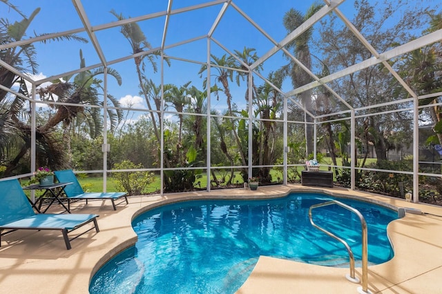 view of swimming pool with a patio area and glass enclosure