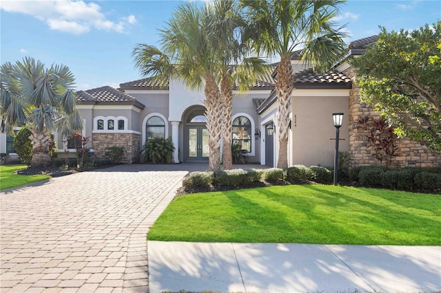 mediterranean / spanish-style house with a front yard