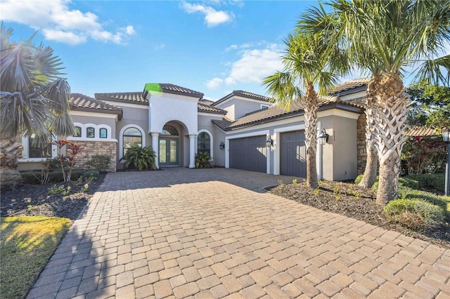 mediterranean / spanish-style house with a garage