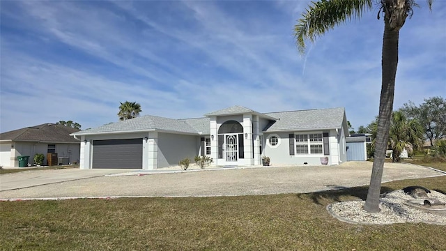 view of front of home featuring a garage and a front lawn