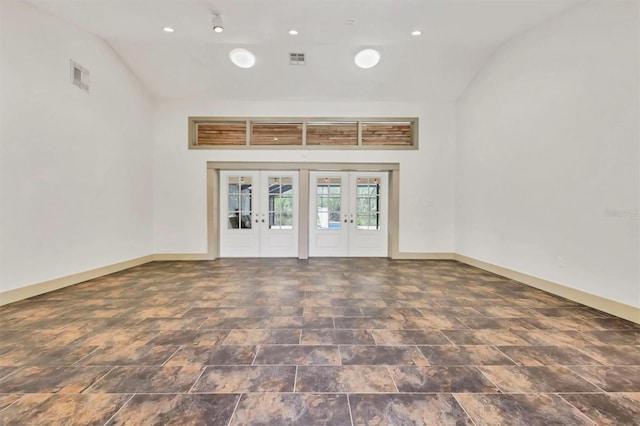 empty room featuring visible vents, french doors, and baseboards