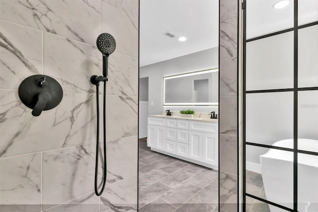 bathroom with a sink, double vanity, visible vents, a marble finish shower, and recessed lighting