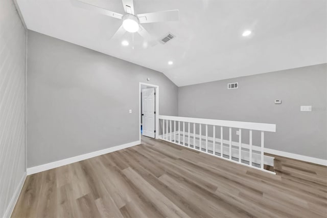spare room featuring recessed lighting, wood finished floors, a ceiling fan, visible vents, and lofted ceiling