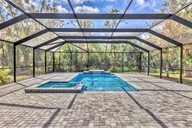 view of pool with a patio and a pool with connected hot tub