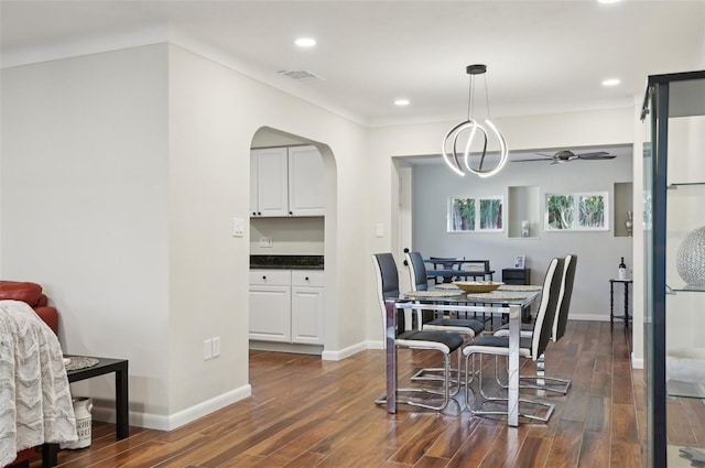 dining space with dark hardwood / wood-style floors and ceiling fan