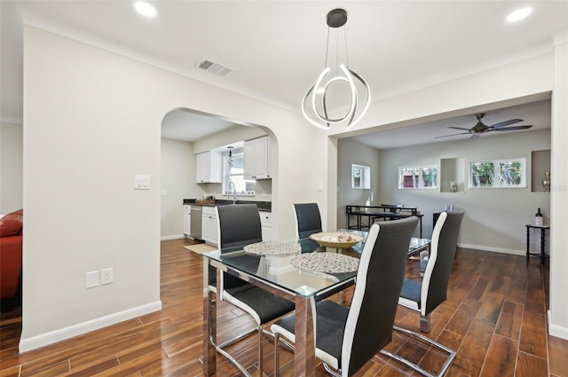 dining room featuring ceiling fan, dark hardwood / wood-style floors, and sink