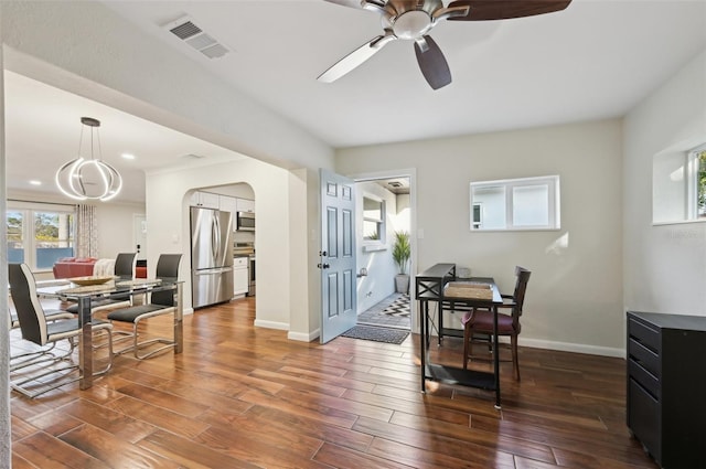 dining room with ceiling fan and dark hardwood / wood-style flooring