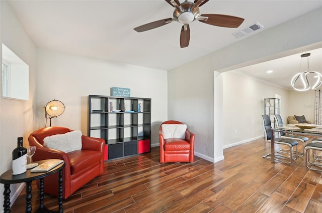 sitting room with dark hardwood / wood-style floors and ceiling fan