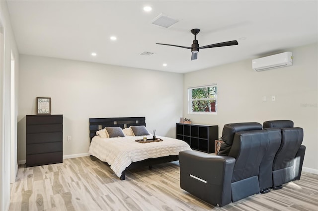 bedroom featuring ceiling fan, a wall mounted AC, and light wood-type flooring