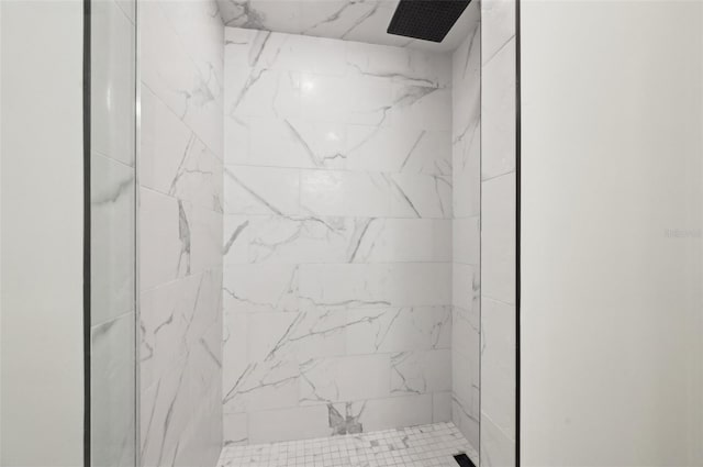 bathroom with tiled shower