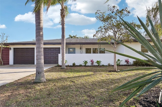 single story home featuring a garage and a front yard