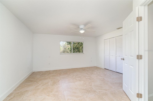 unfurnished room with ceiling fan