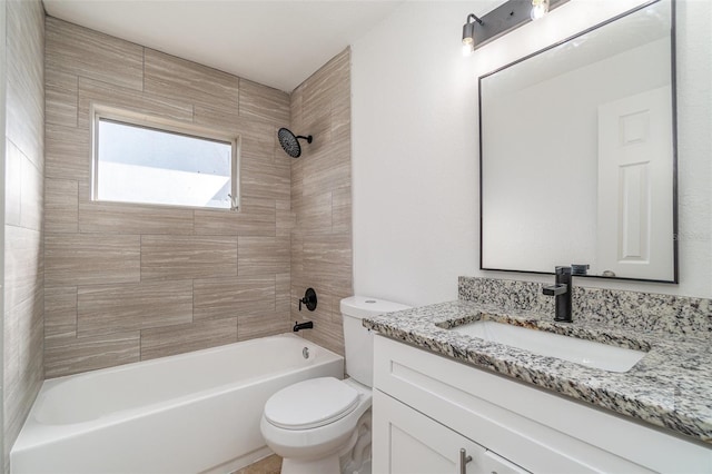 full bathroom with toilet, vanity, and tiled shower / bath