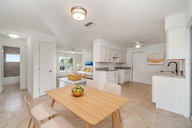 dining area featuring sink and ceiling fan